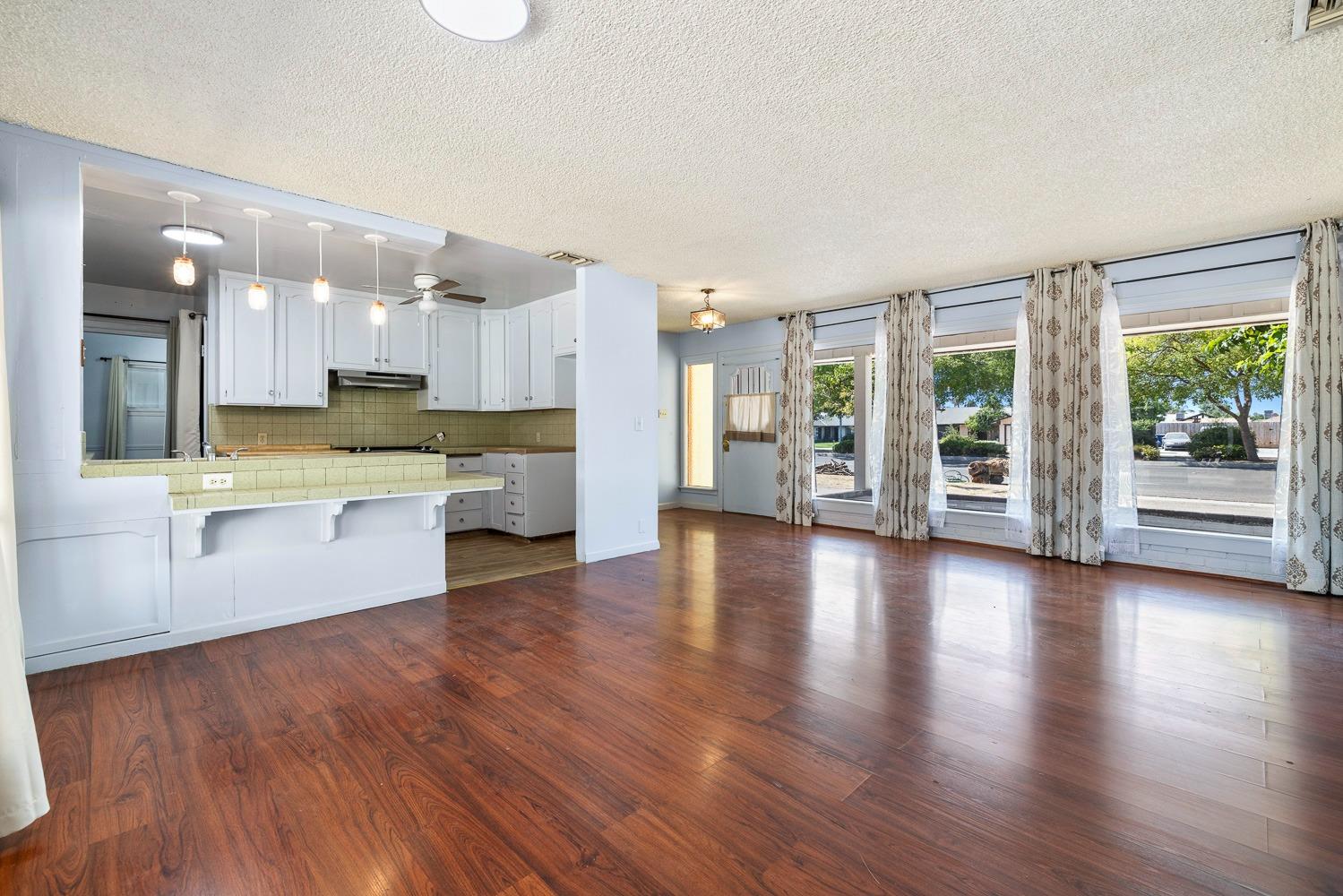 3009 Fowler Avenue Clovis, CA 93611 - Photo 9 of 34 a large kitchen with lots of counter space and wooden floor