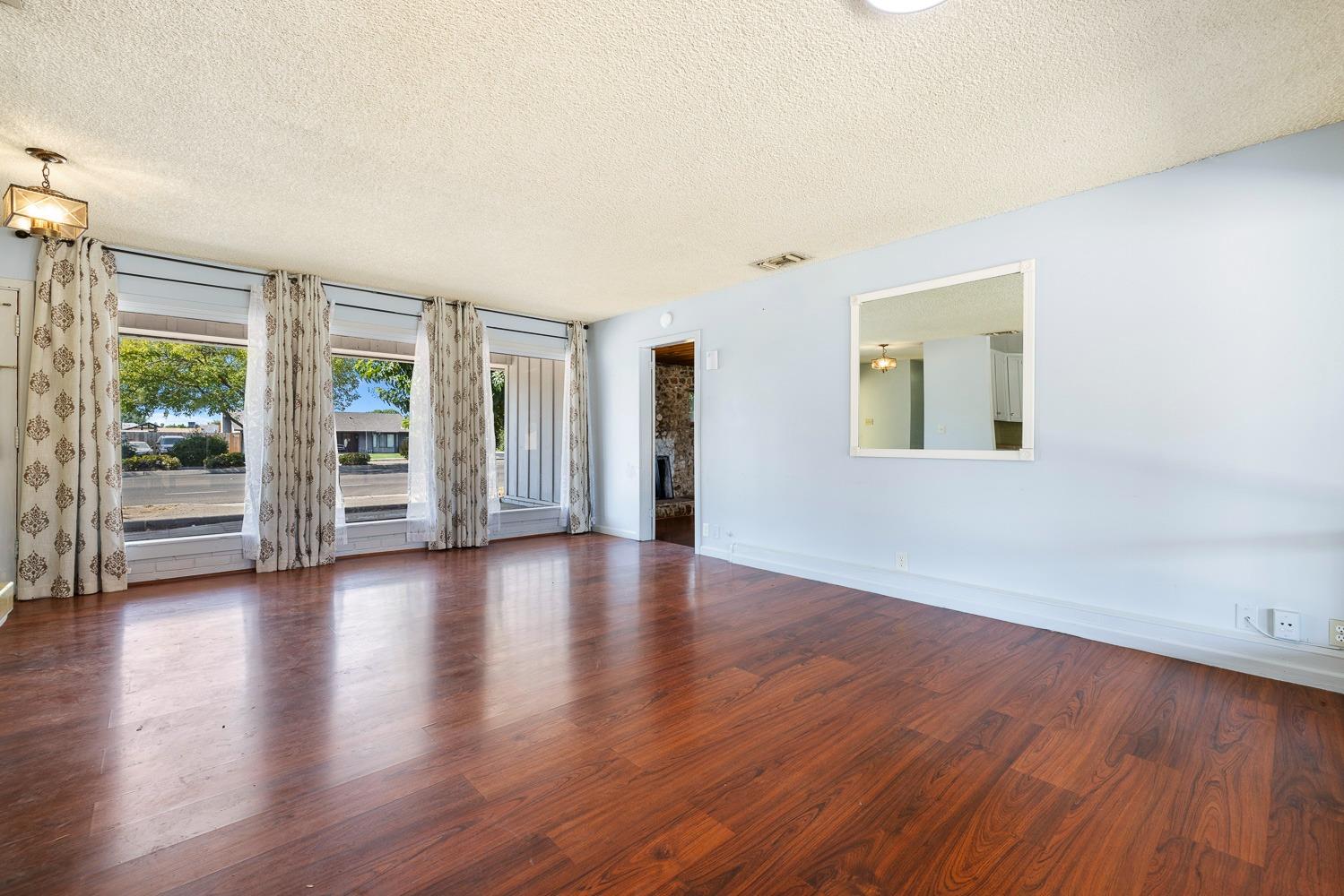 3009 Fowler Avenue Clovis, CA 93611 - Photo 10 of 34 an empty room with wooden floor and windows