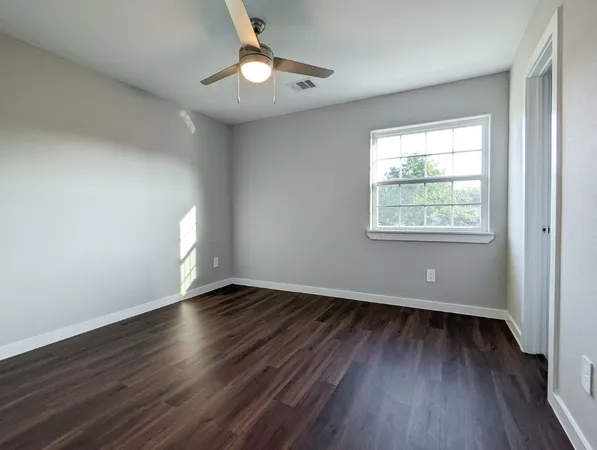 a bathroom with a granite countertop sink a toilet and bathtub