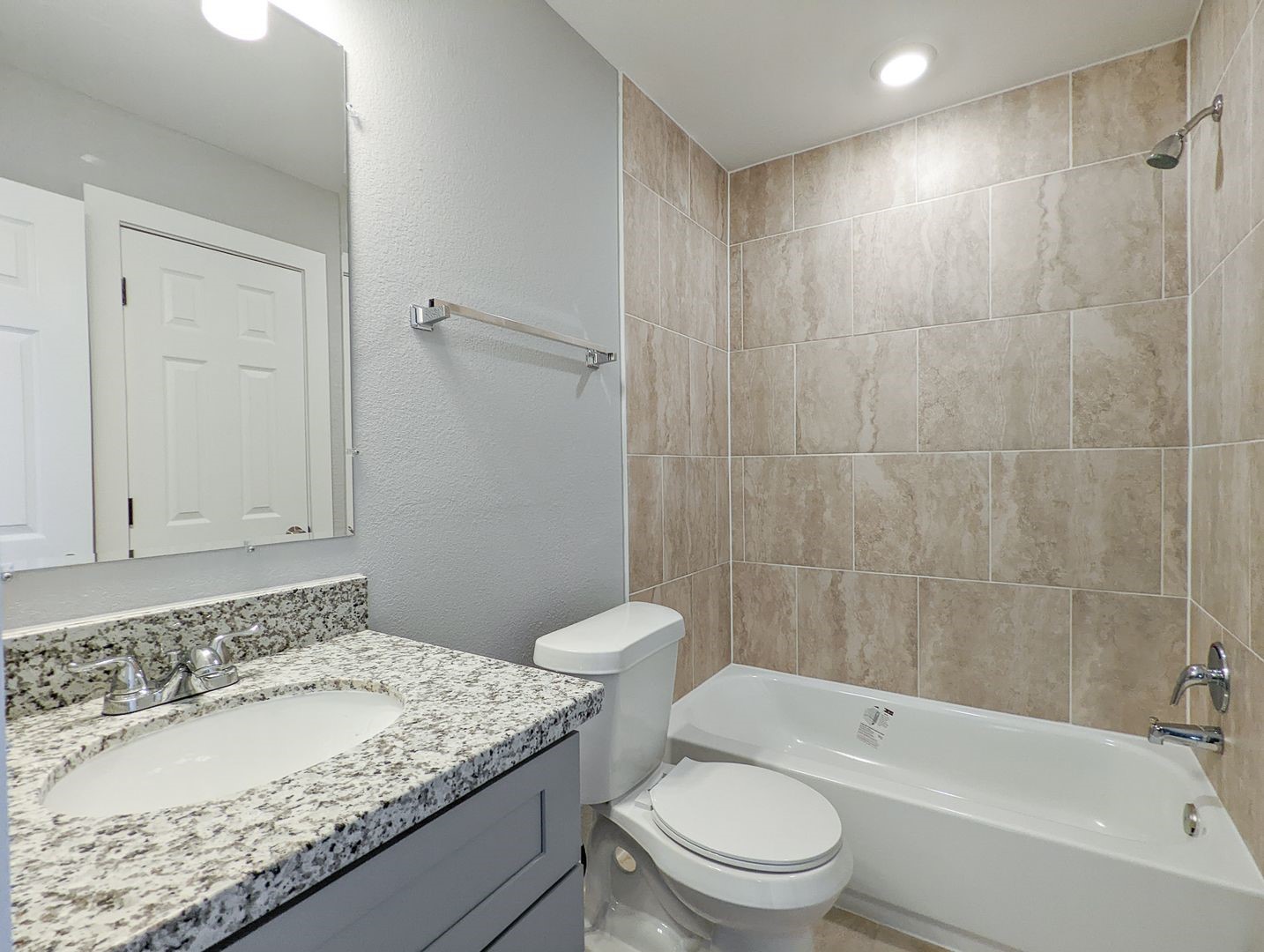 6811 Glass Street, Unit B Houston, TX 77016 - Photo 13 of 17 a bathroom with a granite countertop sink a toilet and bathtub