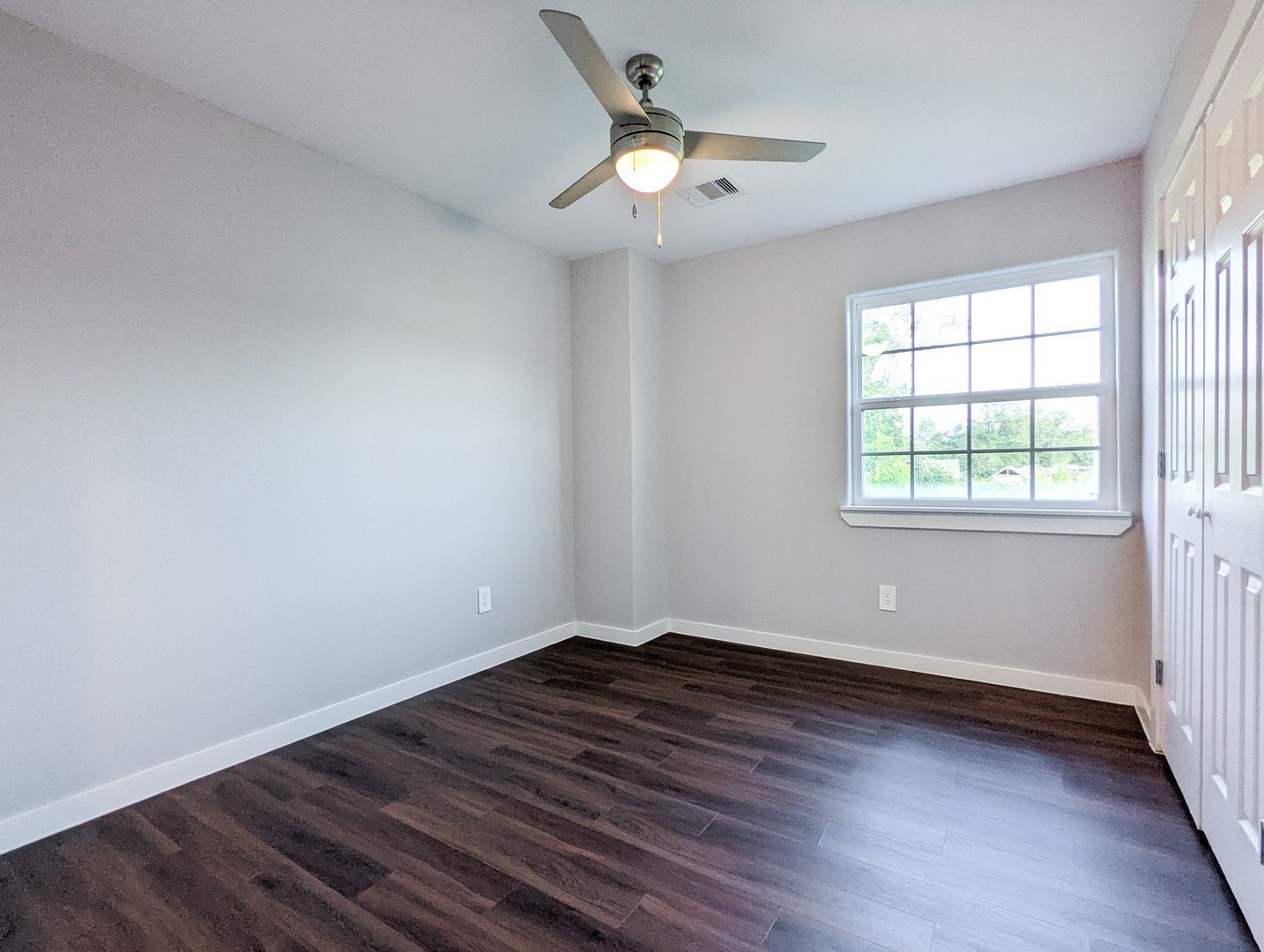 6811 Glass Street, Unit B Houston, TX 77016 - Photo 14 of 17 wooden floor in an empty room with a window