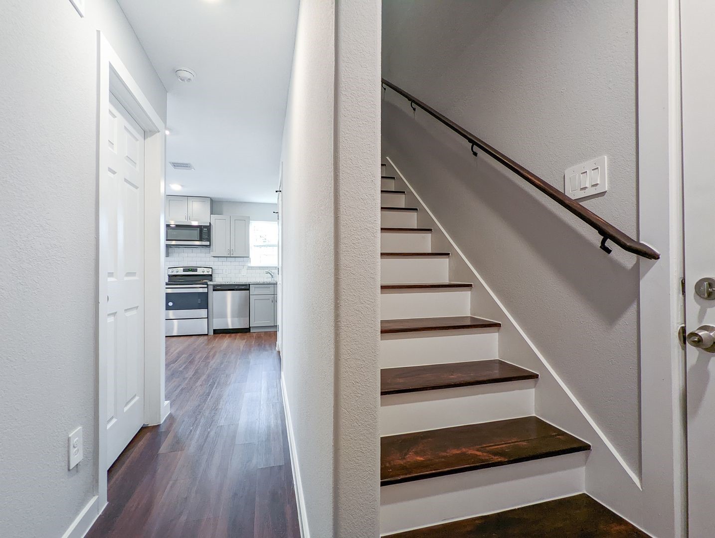 6811 Glass Street, Unit B Houston, TX 77016 - Photo 3 of 17 a view of entryway and kitchen with wooden floor