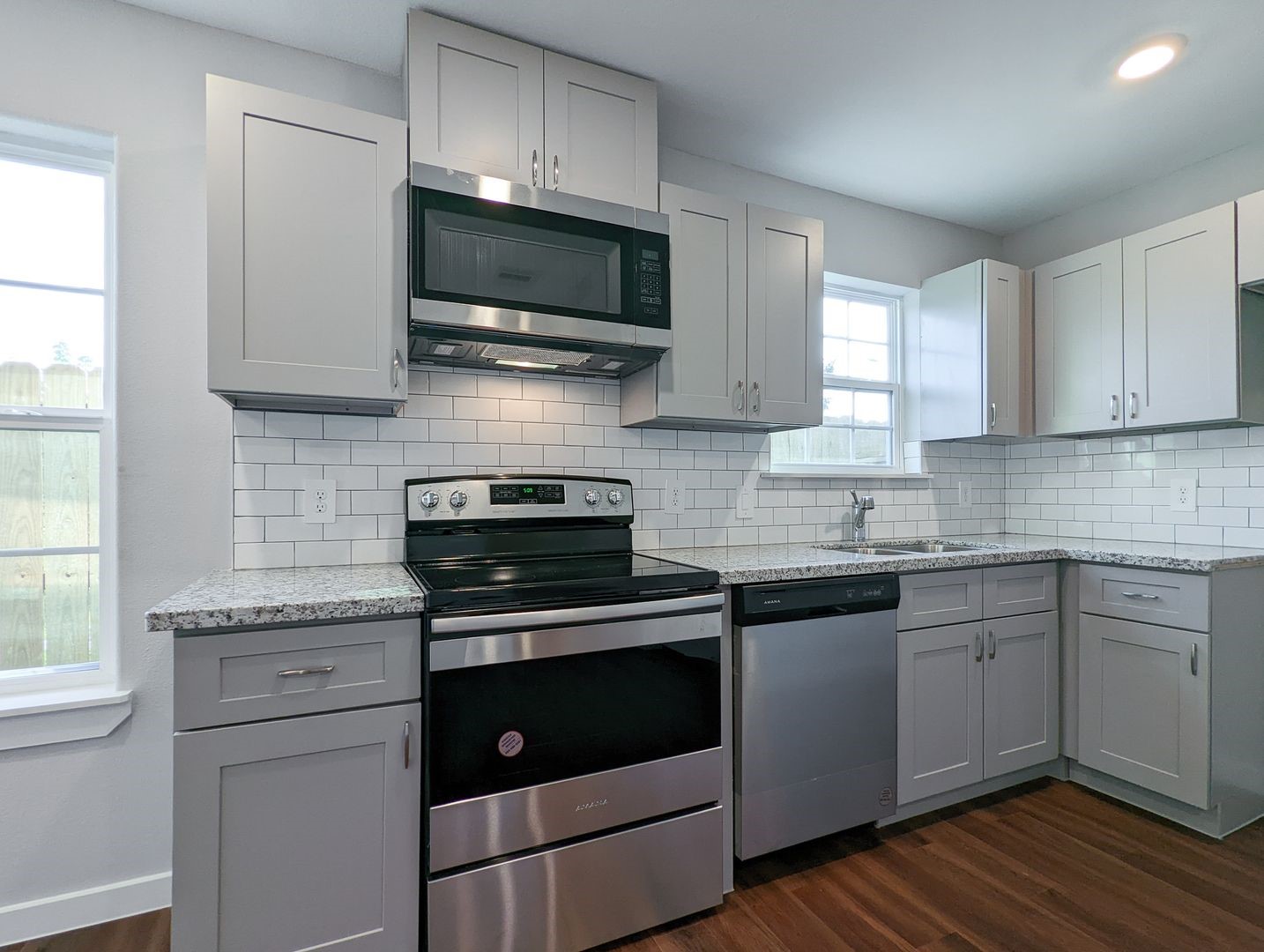 6811 Glass Street, Unit B Houston, TX 77016 - Photo 7 of 17 a kitchen with cabinets stainless steel appliances and a sink