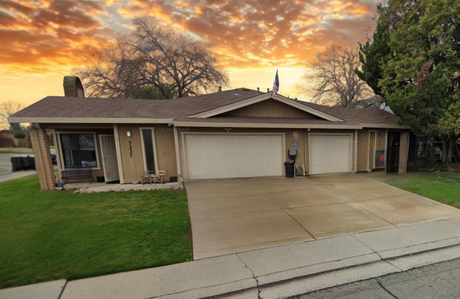 a front view of a house with a garden