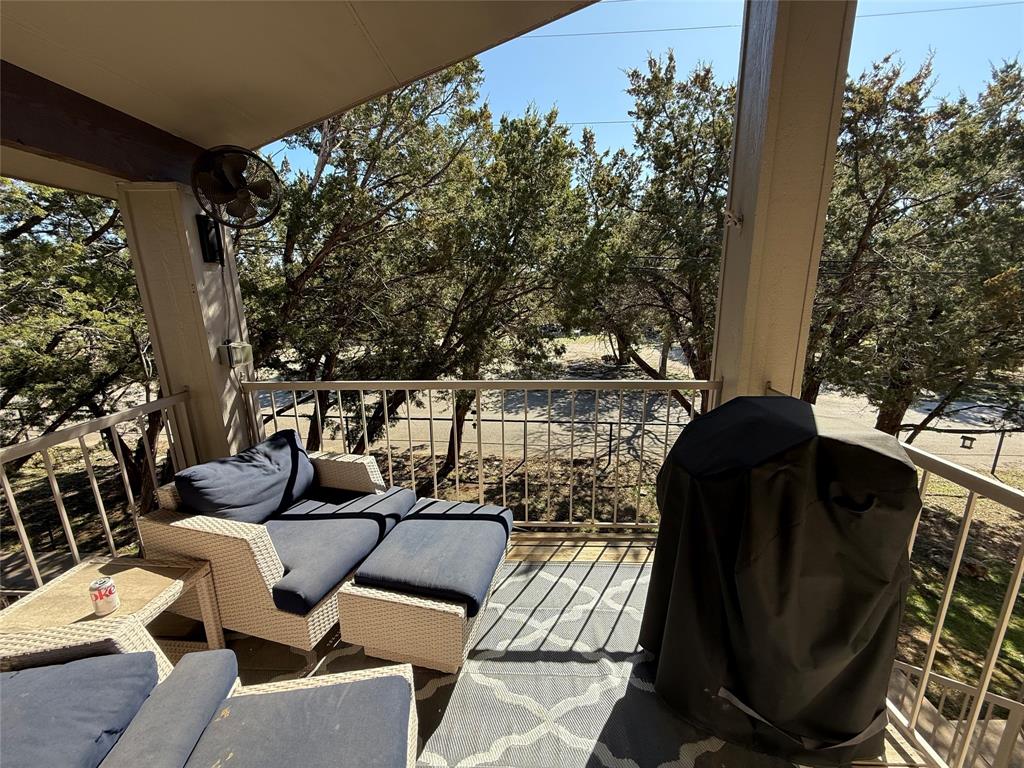 3059 Hells Gate Loop, Unit 8 Strawn, TX 76475 - Photo 14 of 26 a view of balcony with chairs and potted plants