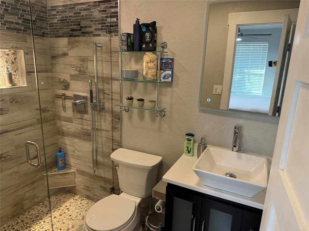 3059 Hells Gate Loop, Unit 8 Strawn, TX 76475 - Photo 6 of 26 a bathroom with a sink toilet and shower