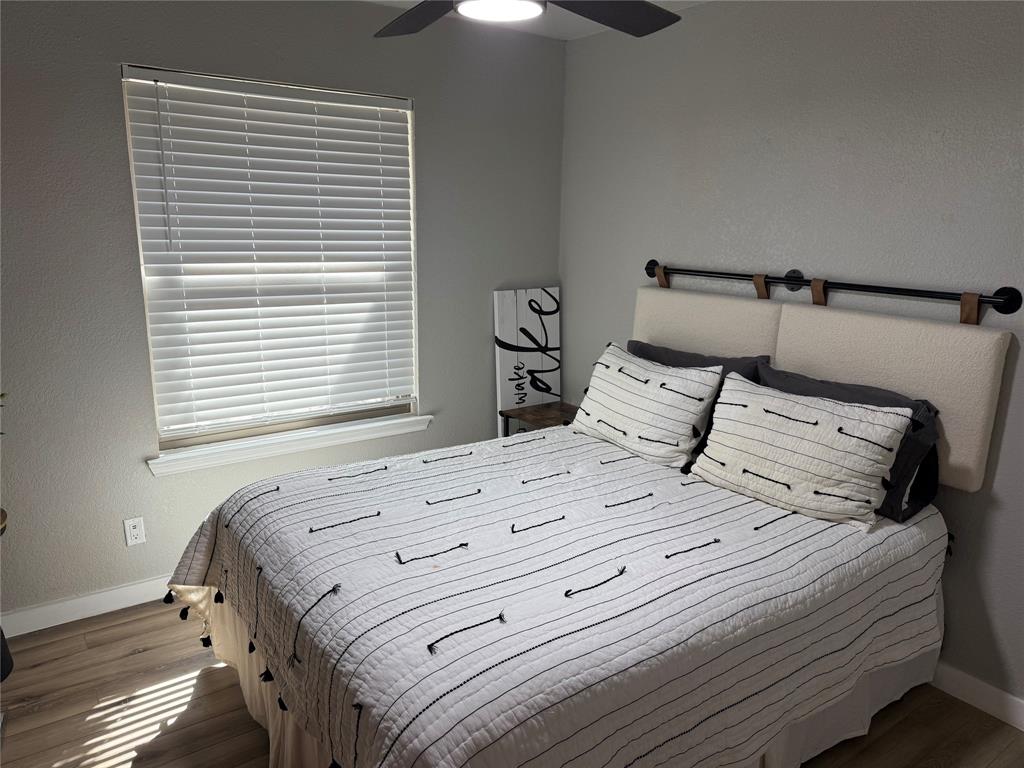 3059 Hells Gate Loop, Unit 8 Strawn, TX 76475 - Photo 7 of 26 a bedroom with a bed and a window