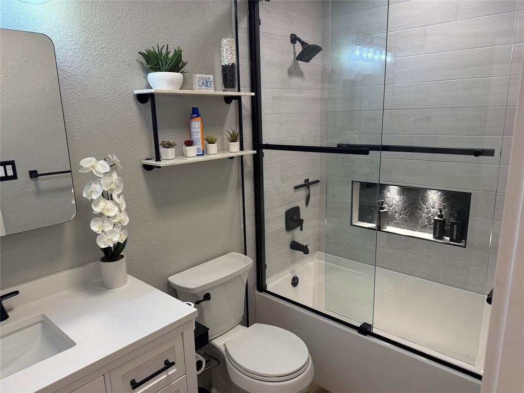 3059 Hells Gate Loop, Unit 8 Strawn, TX 76475 - Photo 8 of 26 a bathroom with a sink toilet and shower