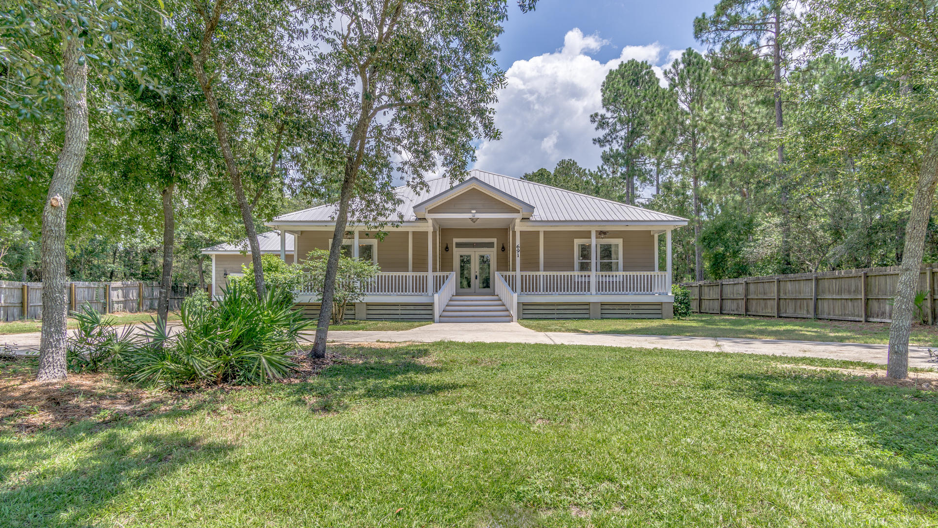 691 Mallet Bayou Road Freeport, FL 32439 - Photo 1 of 49 a front view of a house with a yard and trees