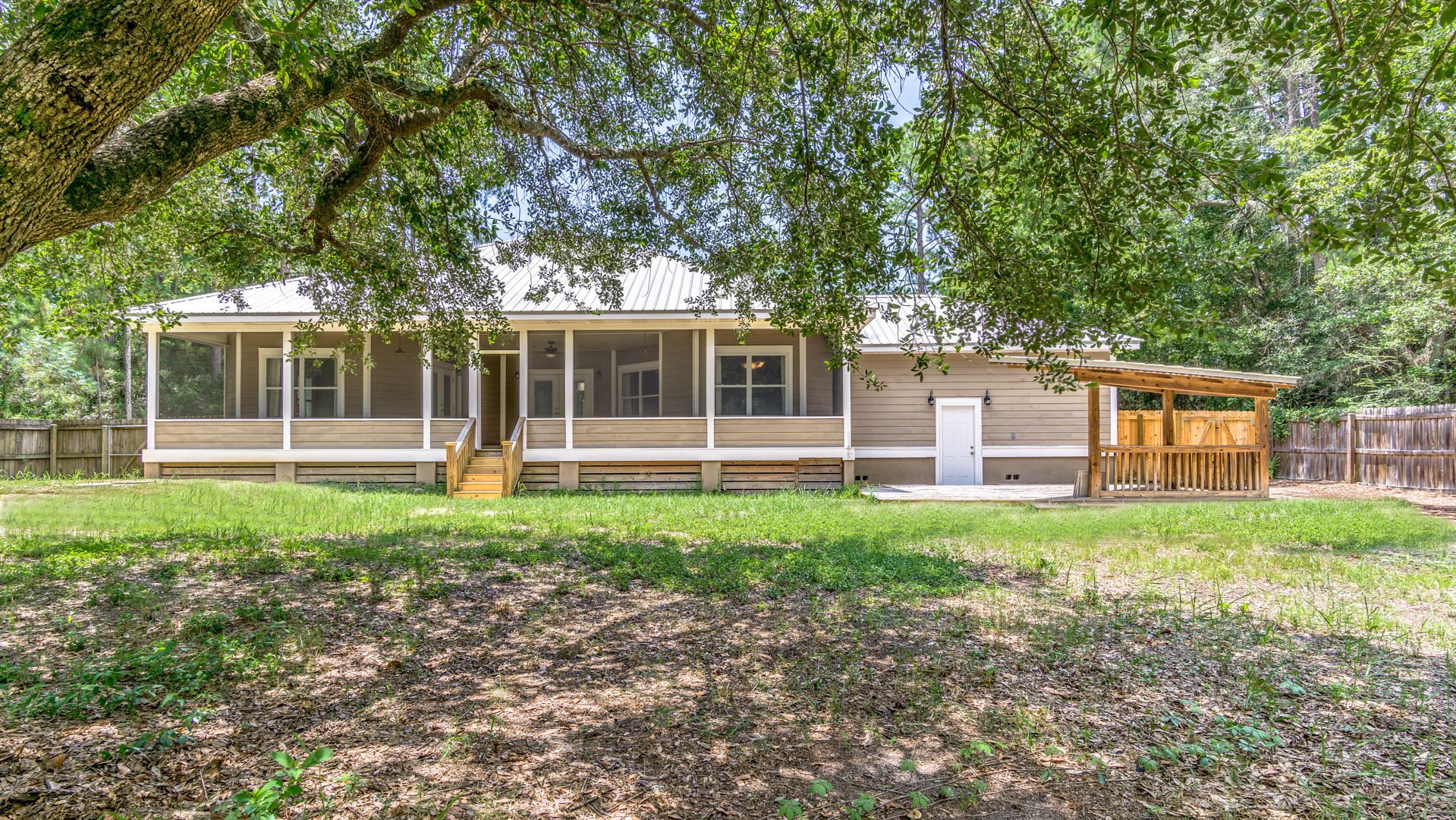 691 Mallet Bayou Road Freeport, FL 32439 - Photo 13 of 49 a view of a house with backyard porch and garden