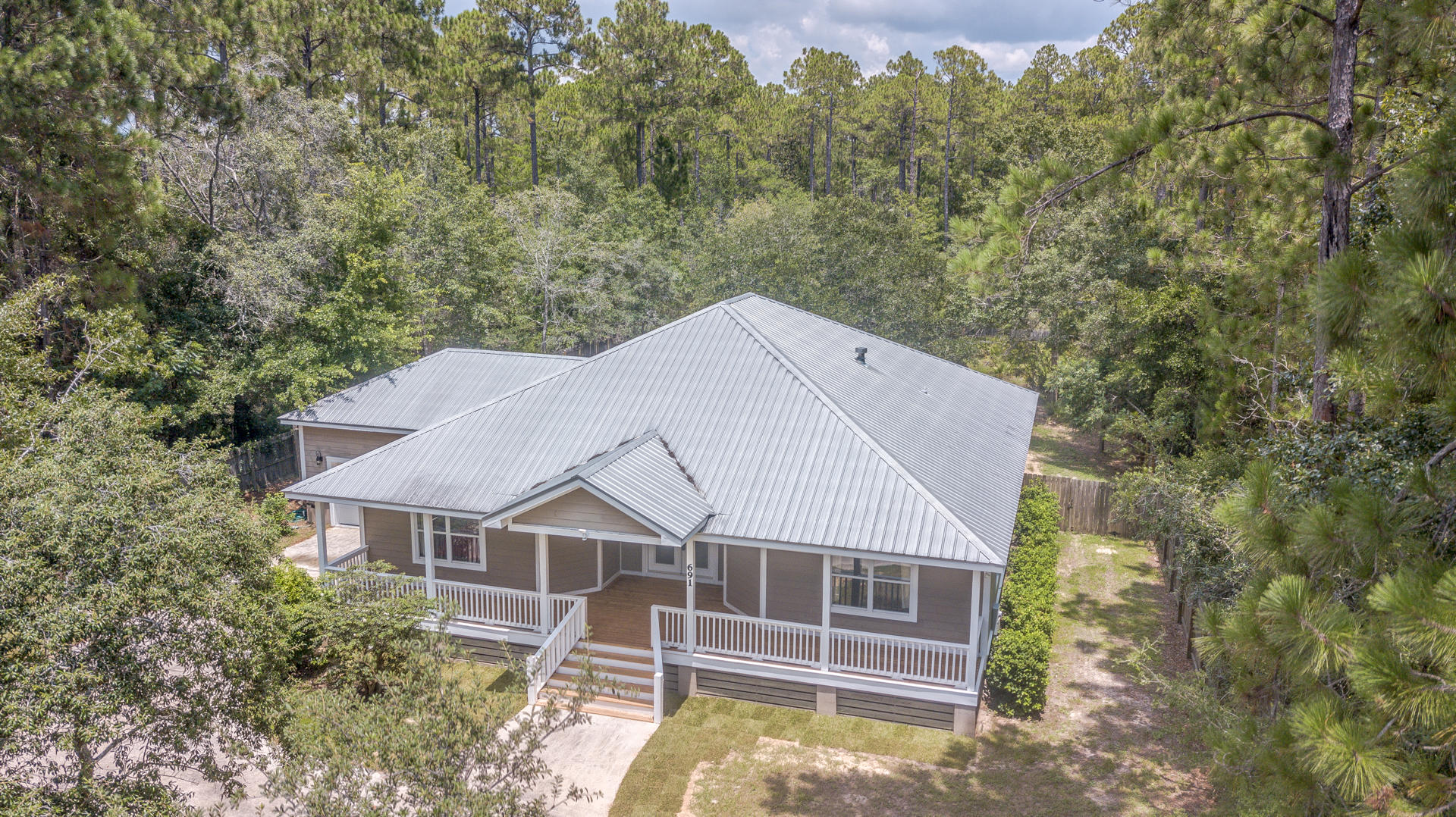 691 Mallet Bayou Road Freeport, FL 32439 - Photo 14 of 49 a white house with a large window and large tree