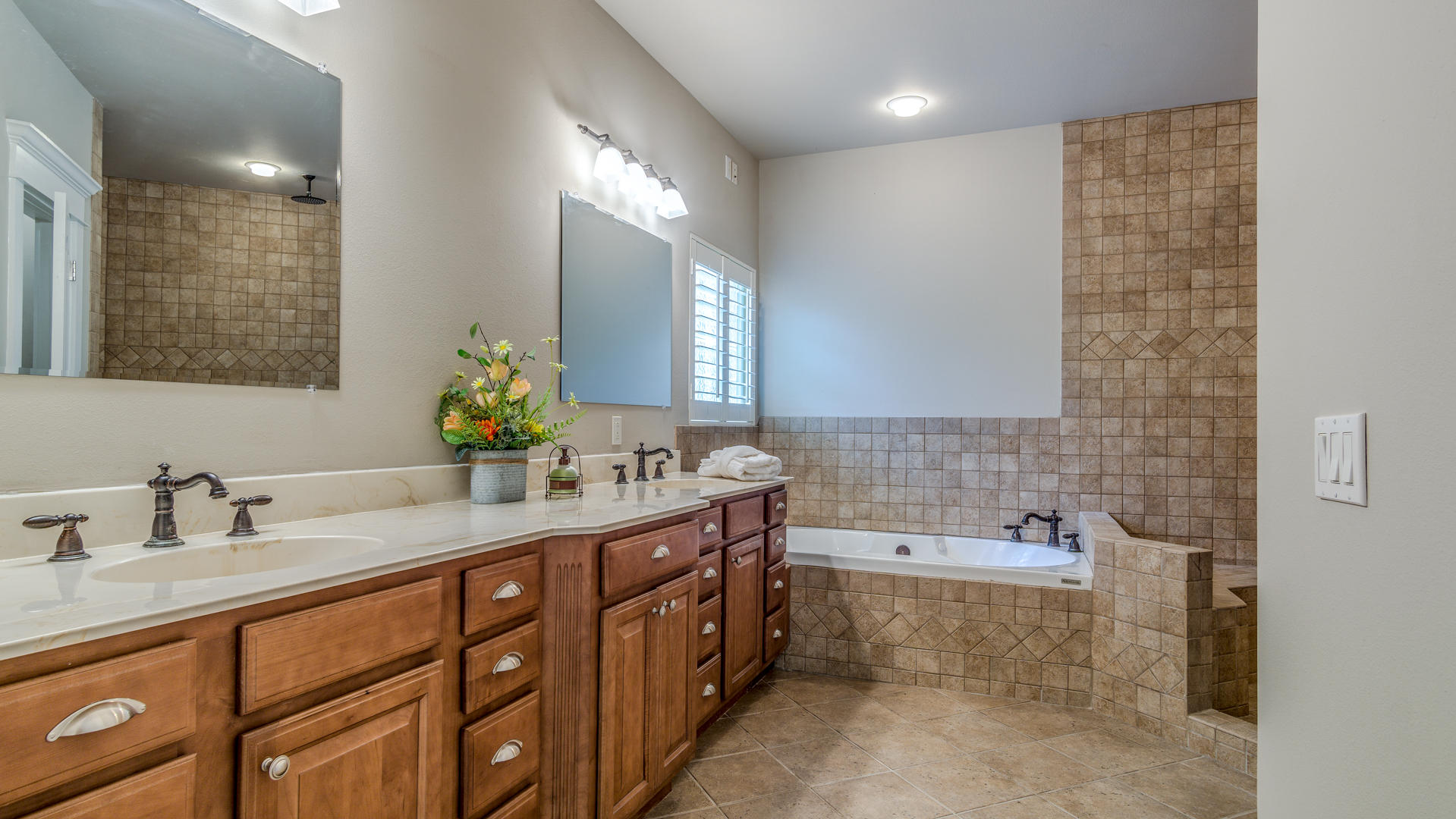 691 Mallet Bayou Road Freeport, FL 32439 - Photo 7 of 49 a bathroom with a double vanity sink a mirror and a bathtub