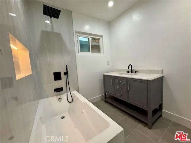 a bathroom with a bathtub and a sink