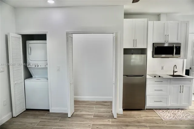 a kitchen with a refrigerator and a stove