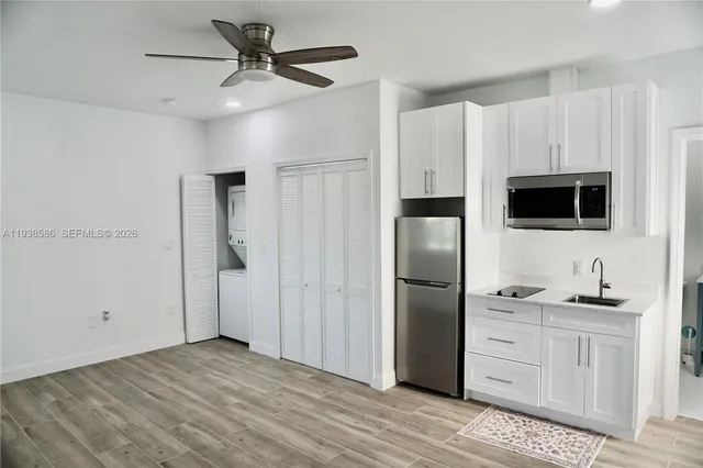 a kitchen with stainless steel appliances a refrigerator and a stove top oven