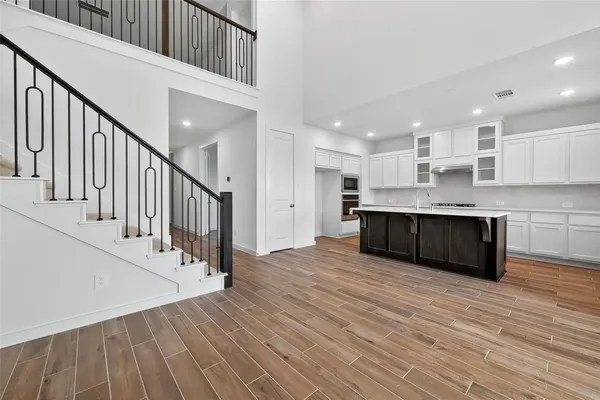 a view of kitchen with wooden floor and electronic appliances