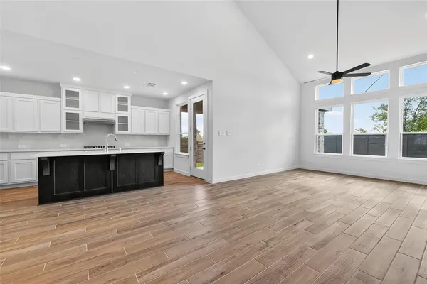 a view of kitchen with granite countertop cabinets and wooden floor