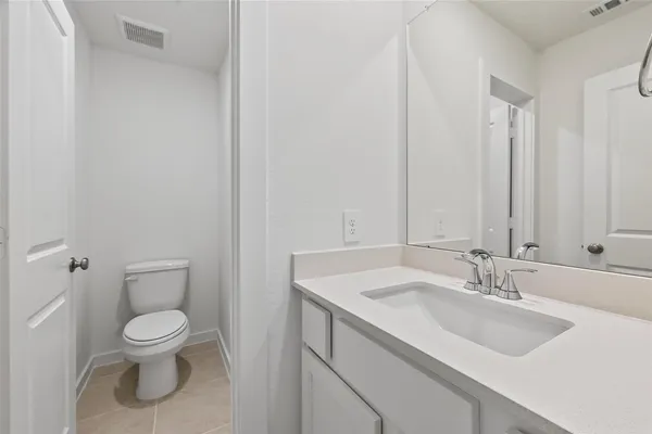 a bathroom with a toilet a sink and a mirror
