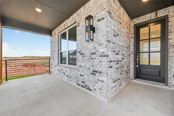 a view of an empty room with a fireplace and a window