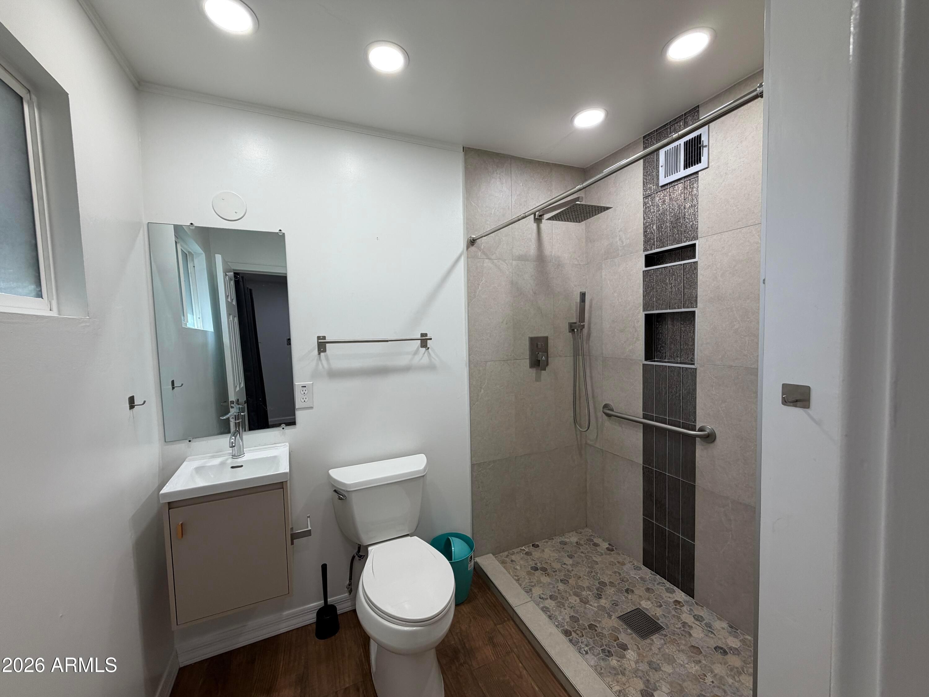2 East Piedmont Road Phoenix, AZ 85042 - Photo 12 of 13 a bathroom with a toilet a sink and shower