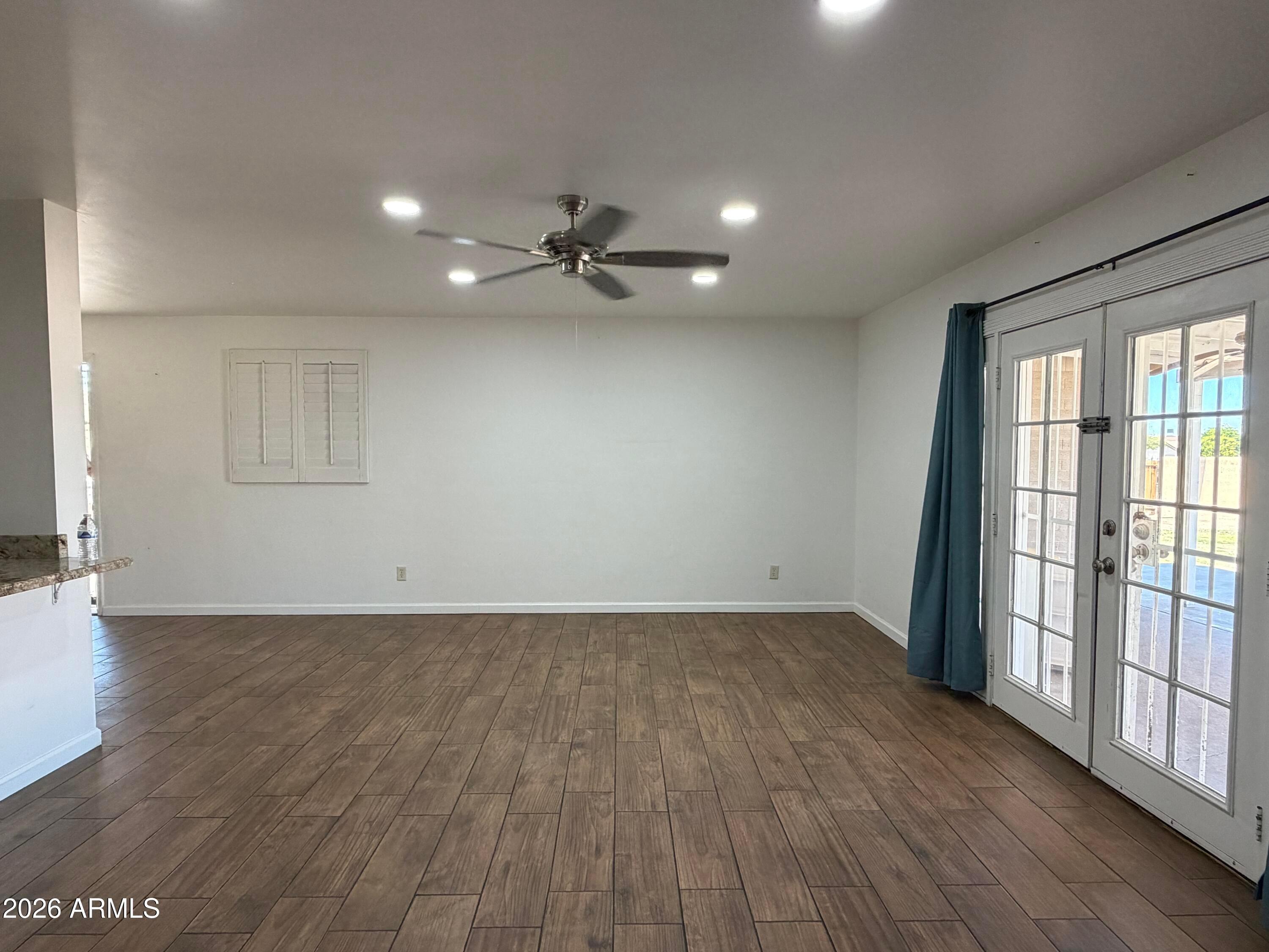 2 East Piedmont Road Phoenix, AZ 85042 - Photo 5 of 13 an empty room with wooden floor and windows