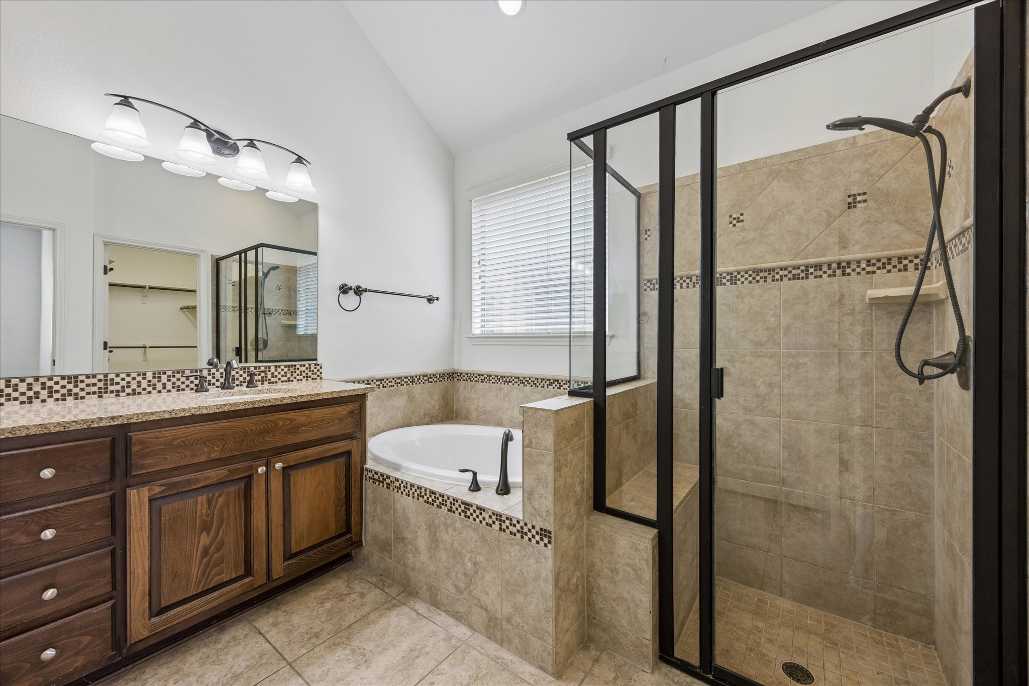 14304 Senia Bend Austin, TX 78738 - Photo 11 of 15 Generously sized primary bathroom features a tub, separate shower, and a large vanity with ample storage.