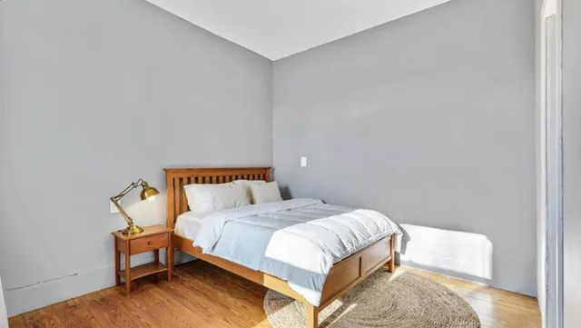 a bedroom with a bed and chair