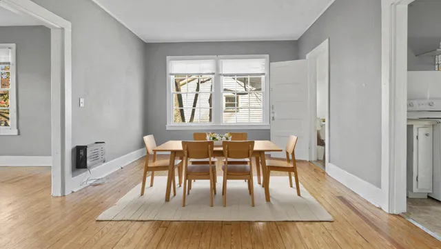 a dining room with furniture and wooden floor