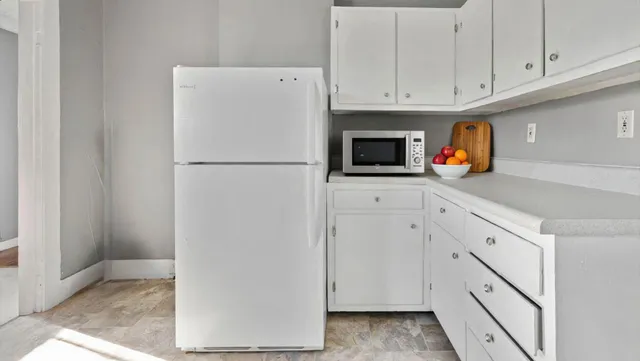 a white refrigerator freezer sitting inside of a kitchen