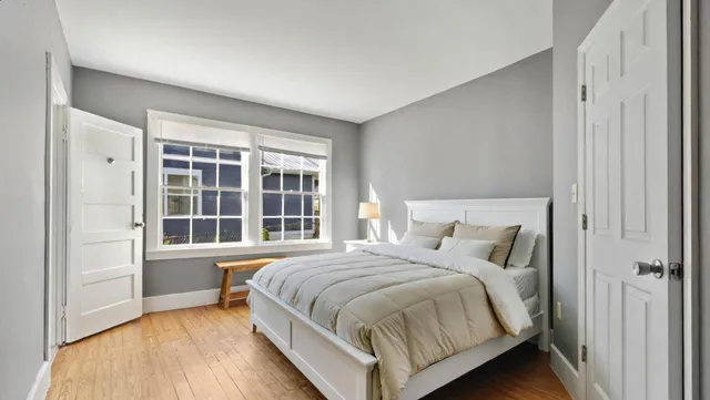 a bedroom with a bed and a window