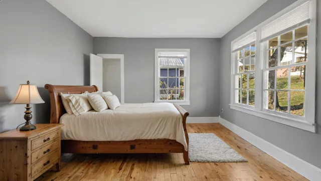 a bedroom with a large bed and a window