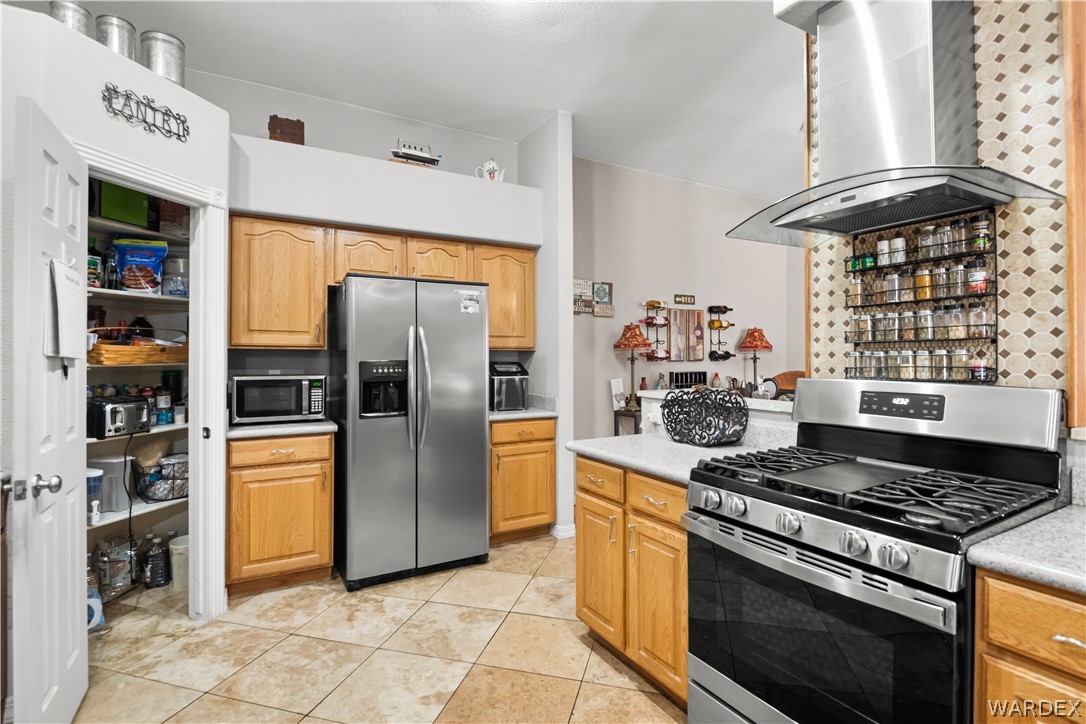 2898 Mountain Trail Road Kingman, AZ 86401 - Photo 11 of 75 a kitchen with stainless steel appliances granite countertop a stove and a refrigerator