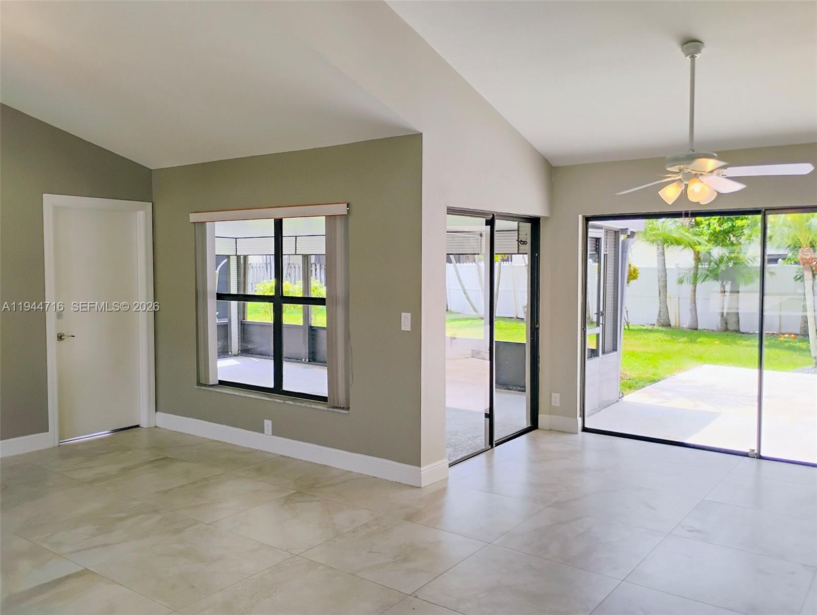 9654 Sun Pointe Drive Boynton Beach, FL 33437 - Photo 11 of 52 an empty room with floor to ceiling window and yard