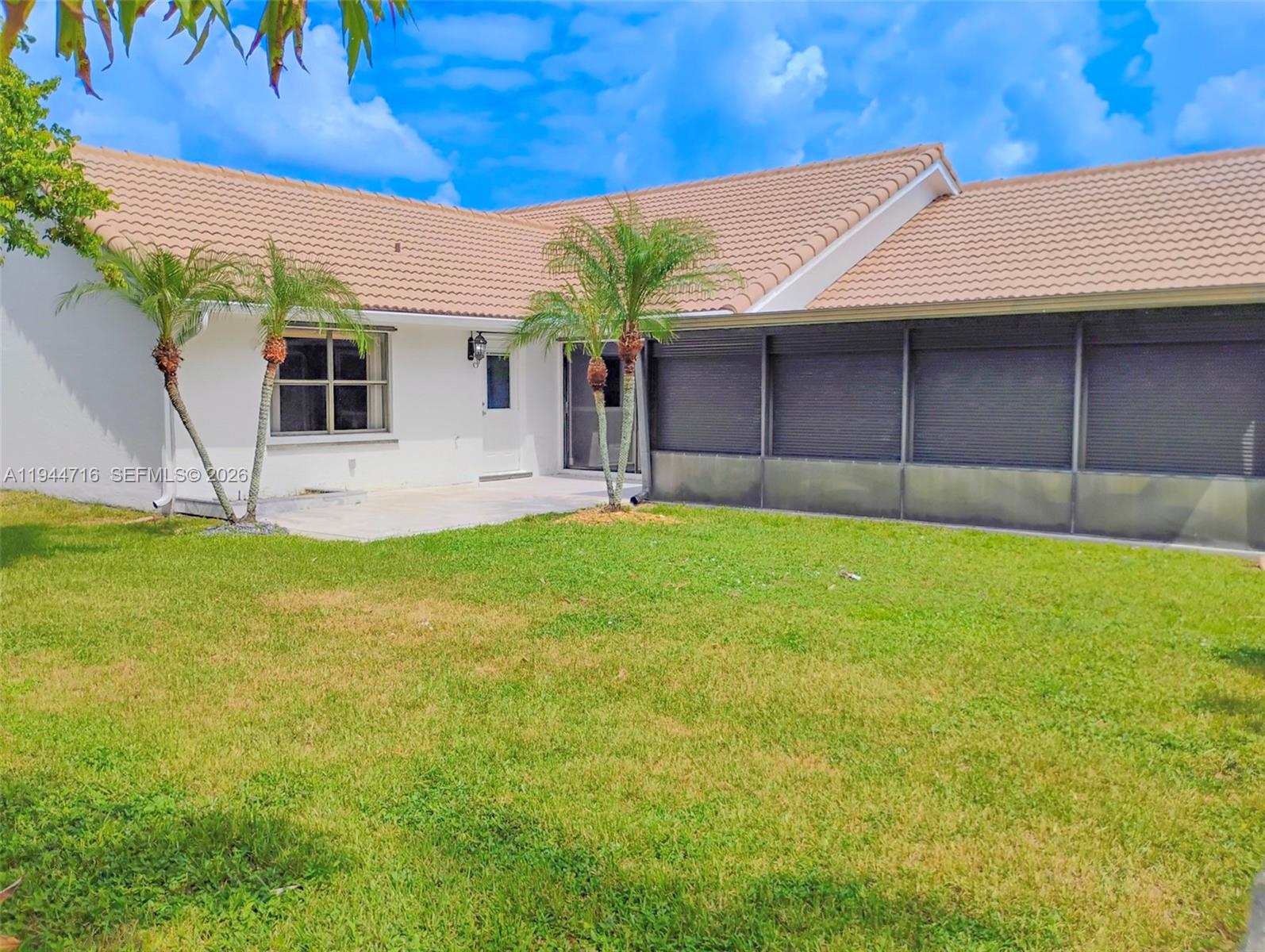 9654 Sun Pointe Drive Boynton Beach, FL 33437 - Photo 15 of 52 a front view of a house with a yard and garage