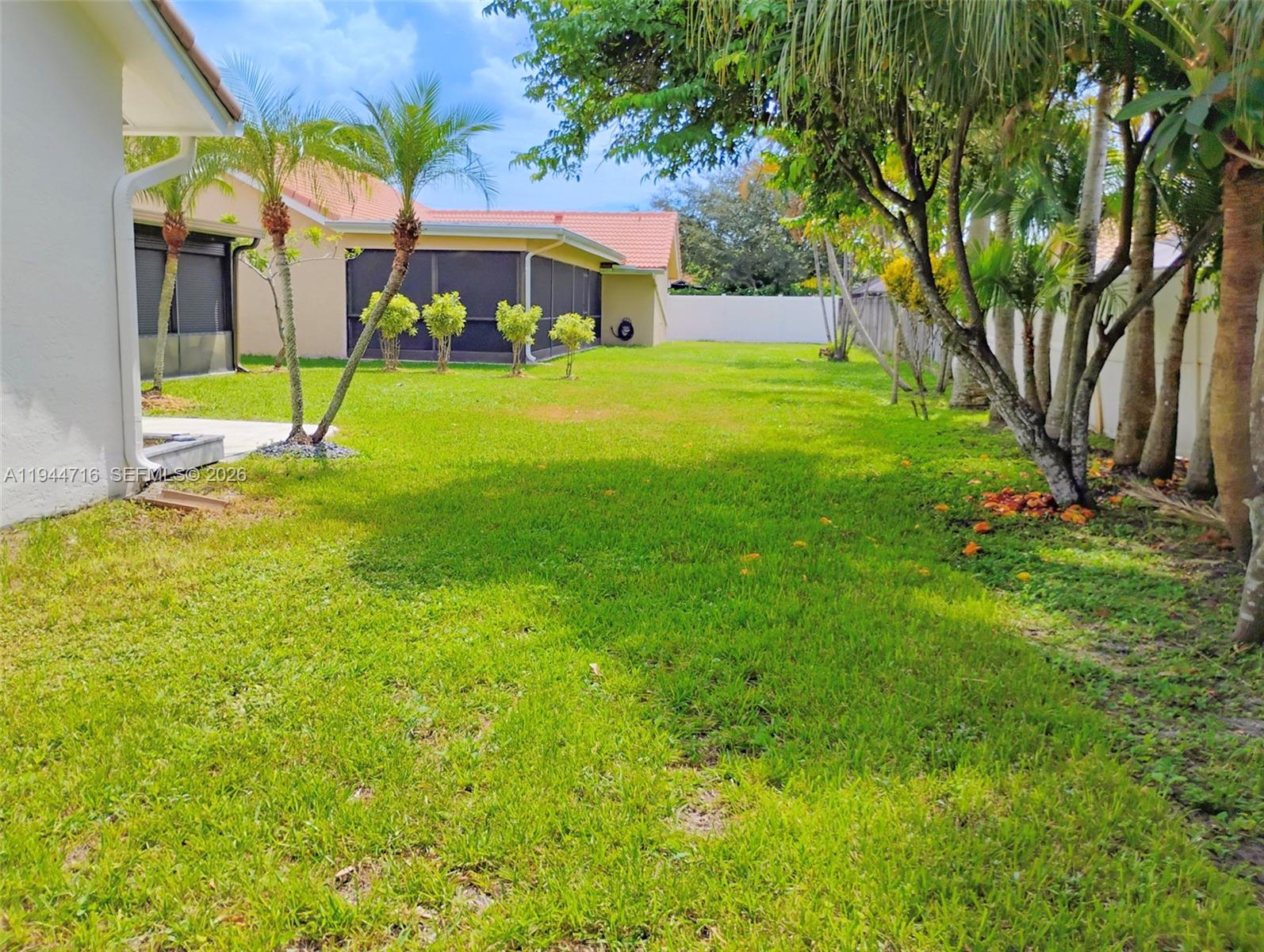 9654 Sun Pointe Drive Boynton Beach, FL 33437 - Photo 19 of 52 a view of a house with a yard