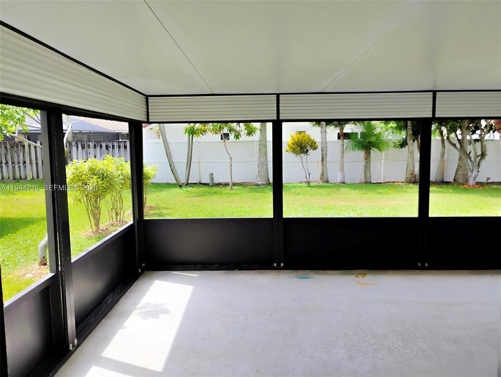 9654 Sun Pointe Drive Boynton Beach, FL 33437 - Photo 21 of 52 a view of an empty room with a large window