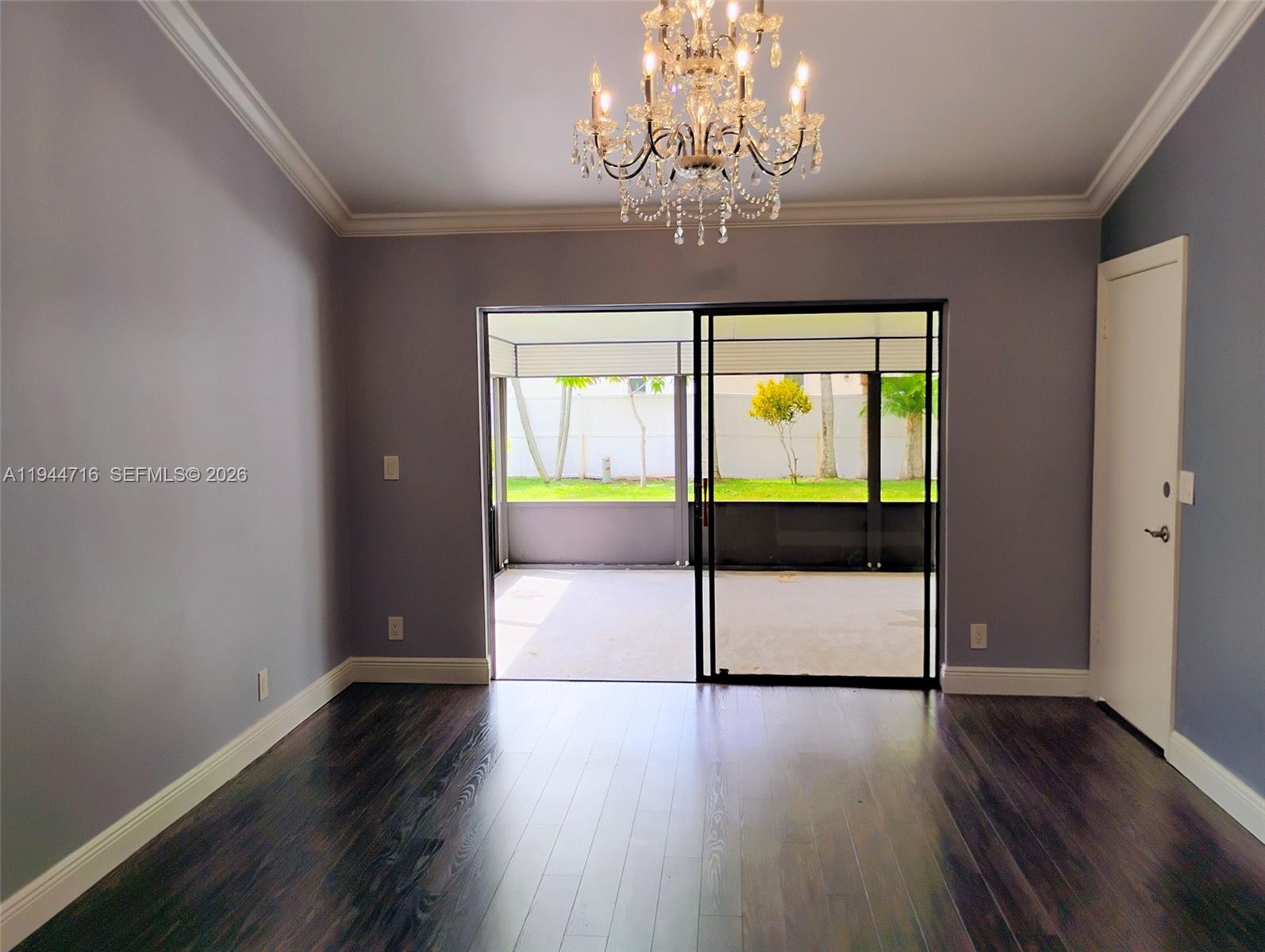 9654 Sun Pointe Drive Boynton Beach, FL 33437 - Photo 24 of 52 a view of an empty room with wooden floor and a window