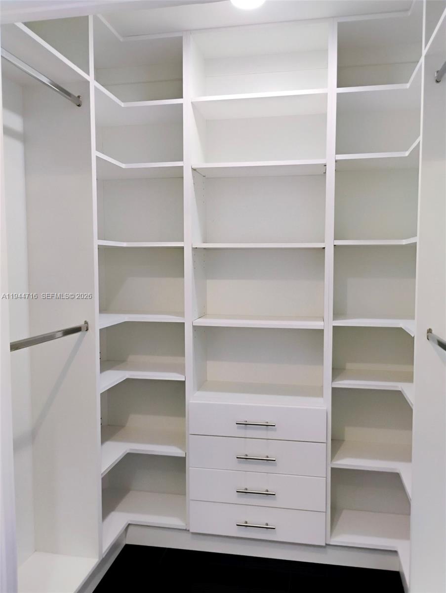 9654 Sun Pointe Drive Boynton Beach, FL 33437 - Photo 28 of 52 a view of walk in closet with empty racks