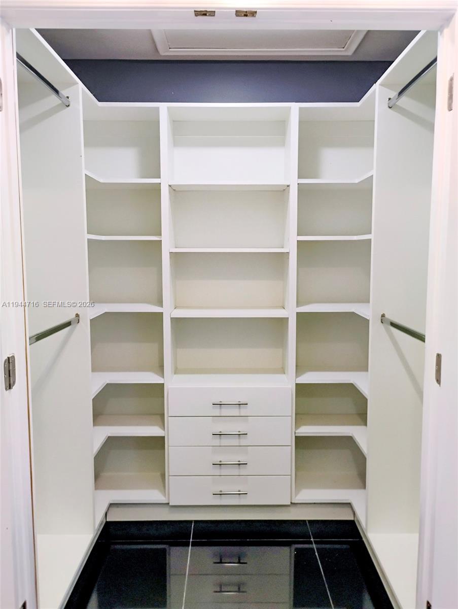 9654 Sun Pointe Drive Boynton Beach, FL 33437 - Photo 29 of 52 a view of walk in closet with empty racks