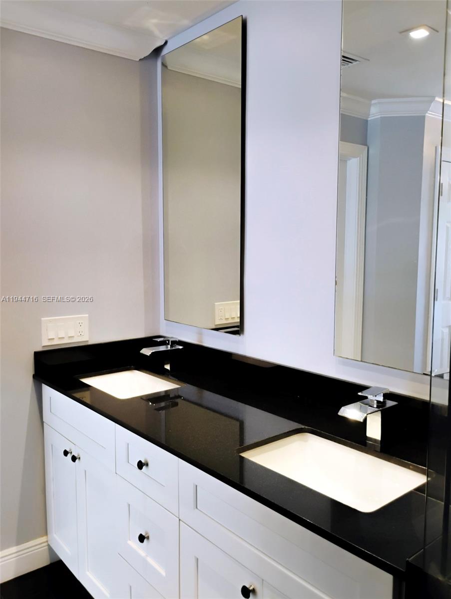 9654 Sun Pointe Drive Boynton Beach, FL 33437 - Photo 30 of 52 a bathroom with a sink and a mirror