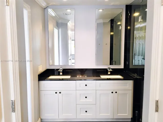 a bathroom with a shower and a sink