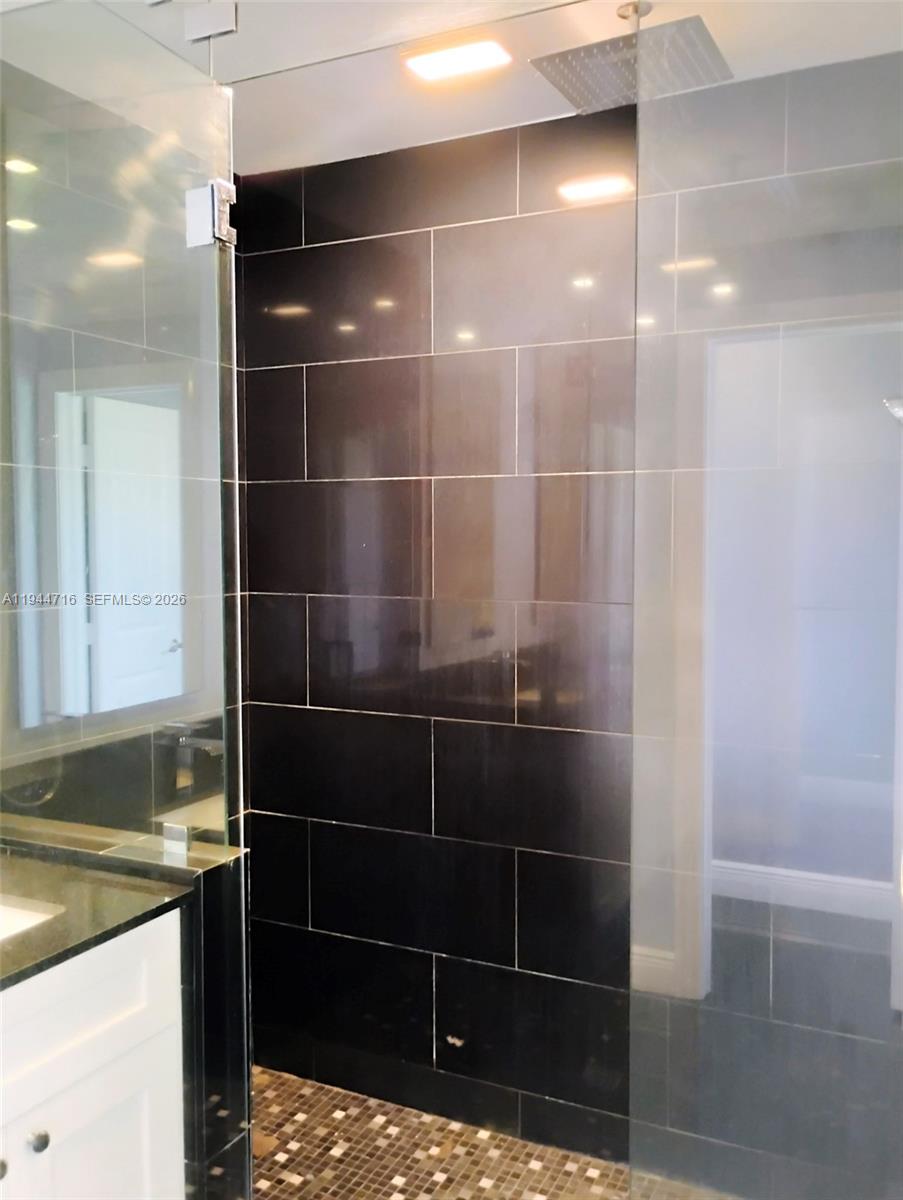 9654 Sun Pointe Drive Boynton Beach, FL 33437 - Photo 33 of 52 a bathroom with a shower and a sink