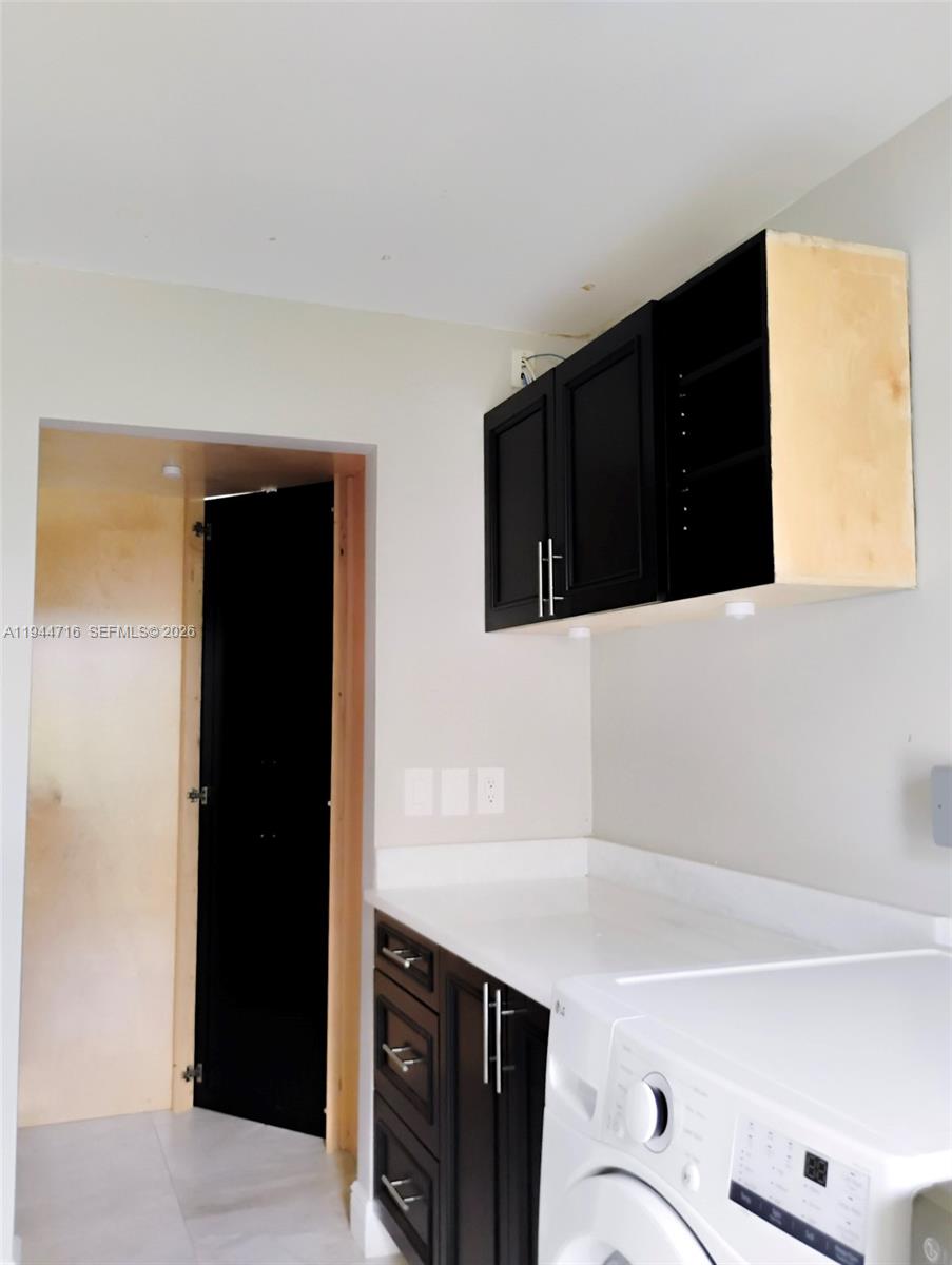 9654 Sun Pointe Drive Boynton Beach, FL 33437 - Photo 44 of 52 a kitchen with a sink and cabinets