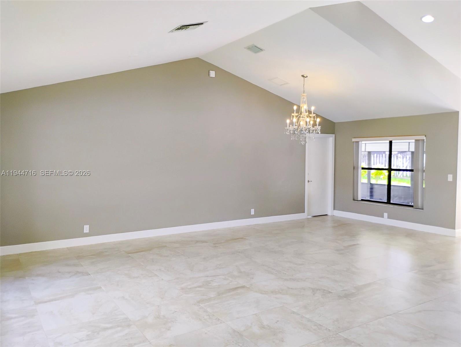 9654 Sun Pointe Drive Boynton Beach, FL 33437 - Photo 6 of 52 wooden floor in an empty room with a window