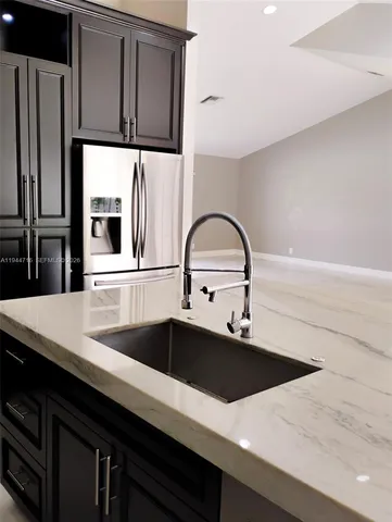 an empty room with floor to ceiling window and yard