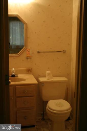 1400 Woodwell Road Silver Spring, MD 20906 - Photo 12 of 20 a bathroom with a toilet sink and mirror
