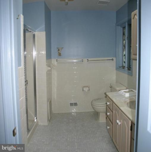 1400 Woodwell Road Silver Spring, MD 20906 - Photo 16 of 20 a bathroom with a granite countertop sink a toilet and shower