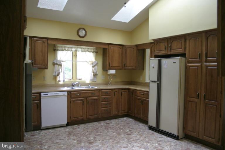 1400 Woodwell Road Silver Spring, MD 20906 - Photo 7 of 20 a kitchen with stainless steel appliances granite countertop a refrigerator and a sink