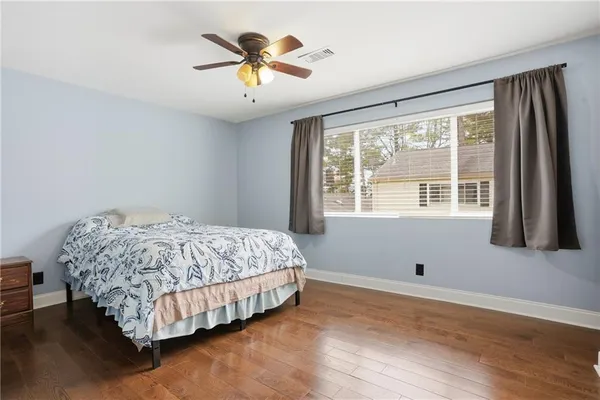a bedroom with a bed and a large window