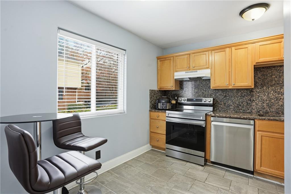 3320 Northcrest Road, Unit C Atlanta, GA 30340 - Photo 9 of 34 a kitchen with stainless steel appliances granite countertop a stove a sink and a microwave